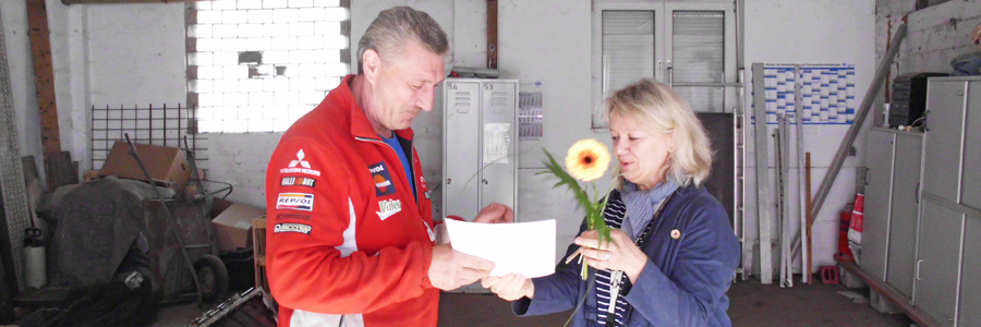 Zum Abschluss der erfolgreichen Qualifizierung erhält Waldemar Minnich von Anke Reimer eine Urkunde und Blumen überreicht.